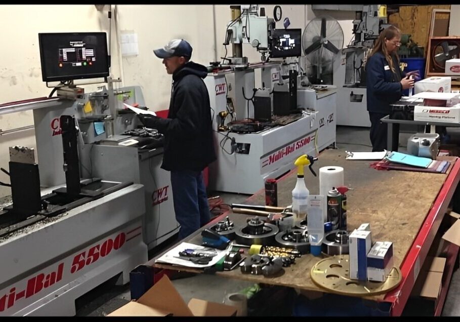 Factory workers operating machinery and assembling parts.